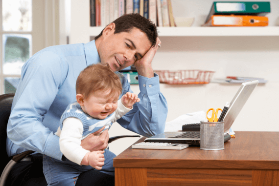 A father trying to work from home being distracted by a crying child
