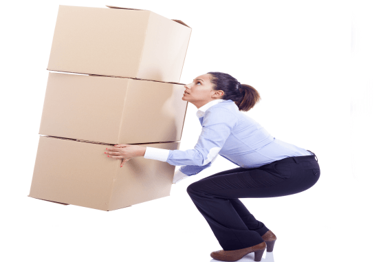 A female office worker lifting a lot of cardboard boxes
