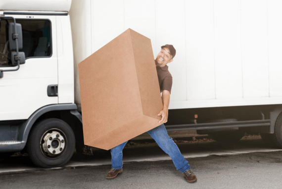 A delivery driver struggling to carry a very large box