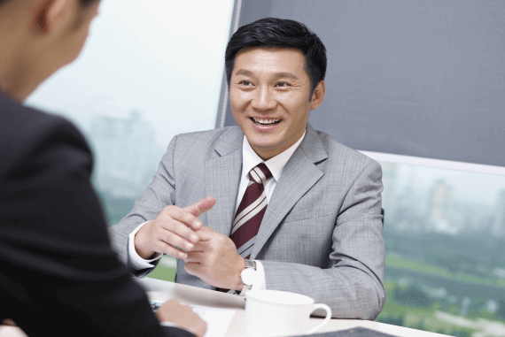 A smiling manager providing career advice to an employee
