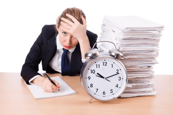 A manager with lots of paperwork and a clock